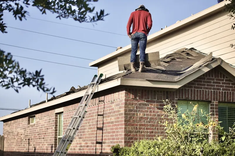 Professional roofer working on a residential roof in Smith Corners